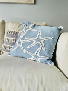 a pillow with a starfish on it sitting on a couch at Luxe appartement op 50 meter van zee in Moraira in Moraira