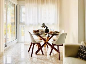 a dining room table and chairs in a room at Luxe appartement op 50 meter van zee in Moraira in Moraira