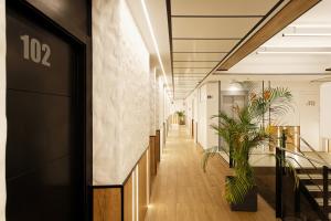 a corridor in a office building with plants at Green House Hotel in Barcelona