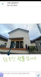 uma foto de uma casa com um cartaz em frente em Gyeongju Sugi's Guesthouse em Gyeongju