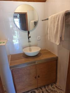 a bathroom with a bowl sink and a mirror at Gusti Home Stay Ubud in Ubud