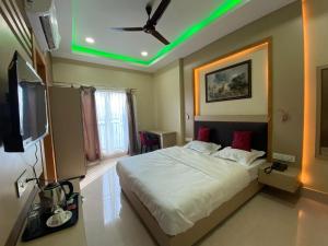 a bedroom with a large bed with a green light at GRACE INN GUEST HOUSE, Near Airport and Ion Digital in Guwahati