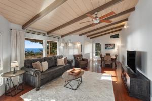 a living room with a couch and a ceiling fan at Walua Trail Estate in Kailua-Kona