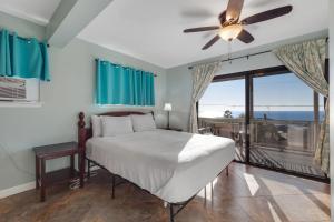 a bedroom with a bed and a large window at Walua Trail Estate in Kailua-Kona