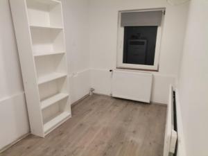 an empty room with white shelves and a mirror at Quiet Residential @ Agglomeration Taplanszentkereszt 2 Bedroom + Living room in Szombathely +2 photos