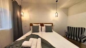 a bedroom with a bed and a chair at MyHome Urban Apartments-Air Conditioning-City Center in Puerto del Rosario