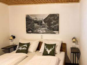 a living room with a couch and a painting on the wall at Spitzen Blicke – Apartments in Silbertal