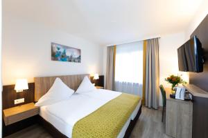 Ένα ή περισσότερα κρεβάτια σε δωμάτιο στο Hotel Alfa