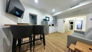 a living room with a bar and a couch at MyHome Urban Apartments-Air Conditioning-City Center in Puerto del Rosario