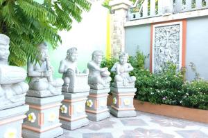 a group of statues in front of a building at Private Bali Artifac GuestHouse in Singaraja