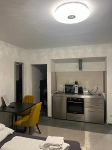 a room with a kitchen and a table with a microwave at House Cologne in Cologne