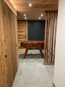 a pool table in the middle of a room at Chalet L'Alpaga in Châtel
