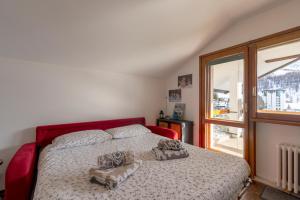 a bedroom with a bed with two pillows on it at [SESTRIERE] Appartamento sulle piste in Sestriere