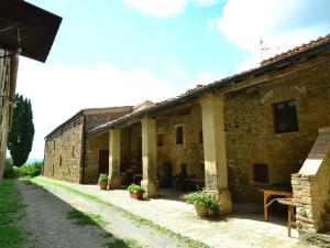 an old stone building with pillars and plants in front at Belvilla by OYO Allodola in Volterra