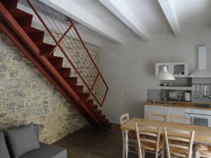 a kitchen and dining room with a staircase in a house at Il Giglio Casa Albergo in Rotondella