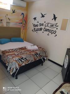 Un pat sau paturi într-o cameră la Pousada João de Barro