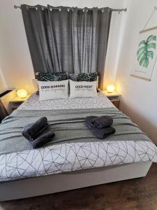 a bedroom with a bed with two towels on it at APARTMENT SIYANA in Panagyurishte