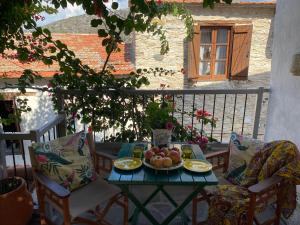 a table with a bowl of fruit on a balcony at Stratos ArtDeco House in Kalavasos