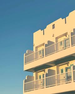 a building with balconies against a blue sky at Little Greece in Nanwan