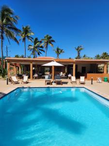 a swimming pool in front of a resort at Cabana Beach Lodge in Cabo Conguiane