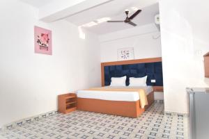a bedroom with a bed and a ceiling fan at TM Calangute House Stay at Goa in Calangute