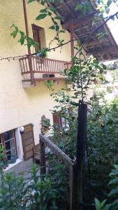 a house with a wooden staircase and a balcony at Maison de village - montagne in Landry