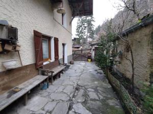 a stone alley with benches next to a building at Maison de village - montagne in Landry