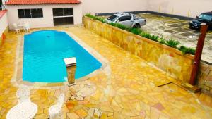 a swimming pool in the backyard of a house at Pousada Serra Branca in São Thomé das Letras