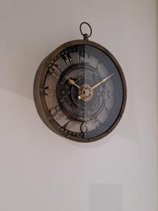 a clock hanging from the ceiling on a wall at Camarote Beach in Nazaré