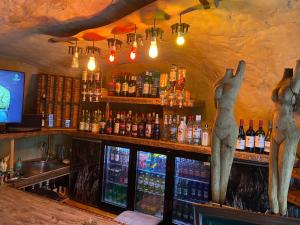 a bar with two statues of people on the counter at Karoozin Village in Oudtshoorn