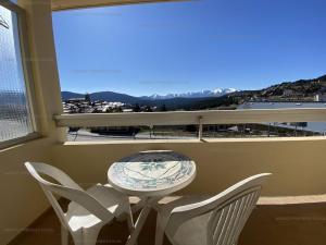 a table and chairs in a balcony with a view at Appartement Les Angles, 1 pièce, 4 personnes - FR-1-295-151 in Les Angles