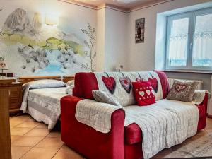 ein Wohnzimmer mit einem Sofa mit Kissen darauf in der Unterkunft Lo scrigno del lago Molveno Trento in Molveno