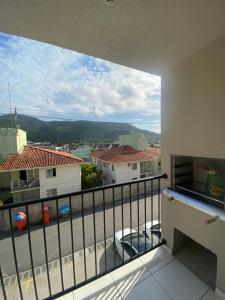 a balcony with a view of a parking lot at Quarto em Florianópolis in Florianópolis