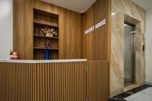 a lobby with a hotel sign on a wooden wall at Studio-Vincent Apartment HaNoi in Hanoi