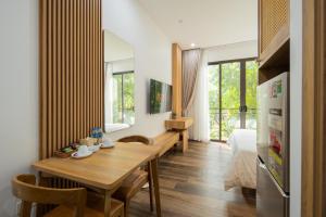 a dining room with a wooden table in a room at Studio-Vincent Apartment HaNoi in Hanoi