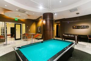 a pool table in a living room with a billiardenge at Sian Oceanfront Condos in Hollywood