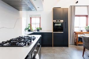 a kitchen with a stove and a counter top at De Zalze Lodge in Stellenbosch