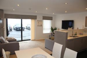 a living room with a view of a parking lot at 1 Island View in Portrush