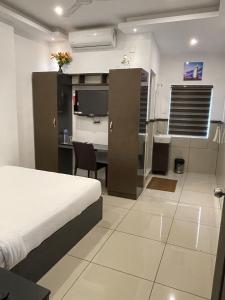 a hotel room with a bed and a desk and a room at ABUDHABI RESIDENCY in Palakkad