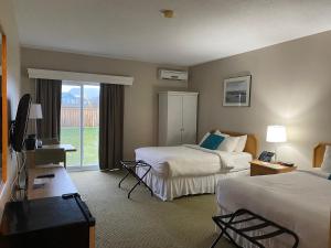 a hotel room with two beds and a television at Ocean View Hotel in Rocky Harbour