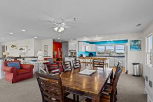 a kitchen and living room with a table and chairs at 7019 - Sara's Sea Breeze by Resort Realty in Rodanthe