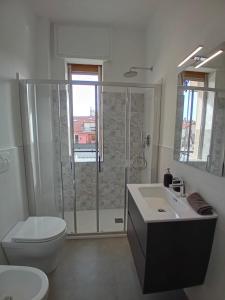 a bathroom with a shower and a toilet and a sink at Loano: Centro e Mare a portata di mano in Loano +17 photos