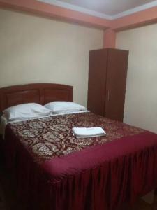 ein Schlafzimmer mit einem Bett mit zwei Handtüchern darauf in der Unterkunft Hotel lucero real 1 in Tacna