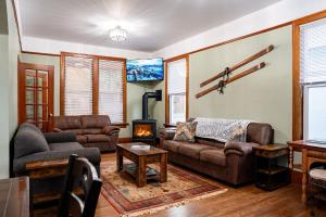 a living room with a couch and a fireplace at Downtown Heritage Home W/ Hot Tub 509 Mackenzie in Revelstoke