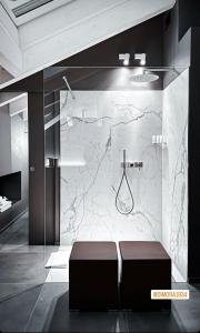 a bathroom with a shower with a bench in front of it at DIMORA1934 Relax&Comfort in Tirano