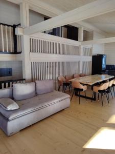 a living room with a couch and a table and chairs at Soul House in Bagna