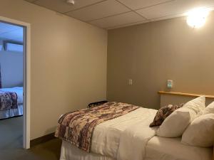 a hotel room with a bed and a window at Ocean View Hotel in Rocky Harbour