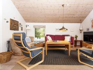 a living room with a couch and a table at 8 person holiday home in Grenaa in Grenå
