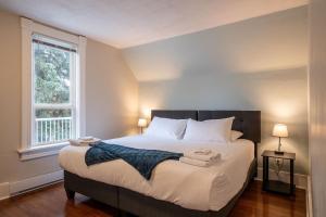 a bedroom with a large bed with towels on it at Downtown Heritage Home W/ Hot Tub 509 Mackenzie in Revelstoke