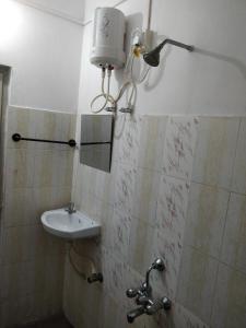 a bathroom with a sink and a mirror at Adarsh Hotel in Port Blair